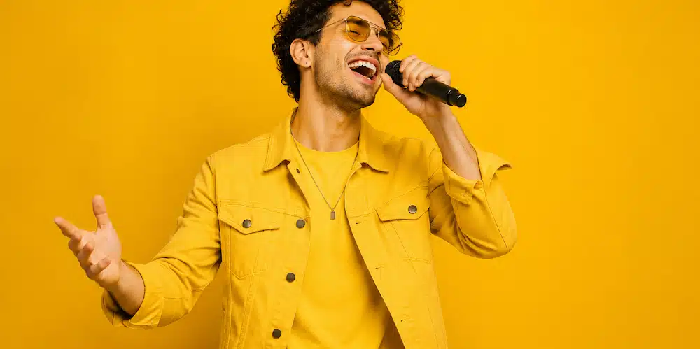 Male vocalist singing into a microphone